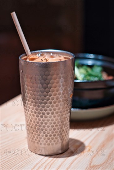 Metal cup with milk tea