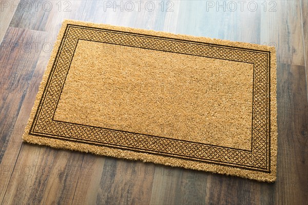 Blank welcome mat on wood floor background ready for your own text