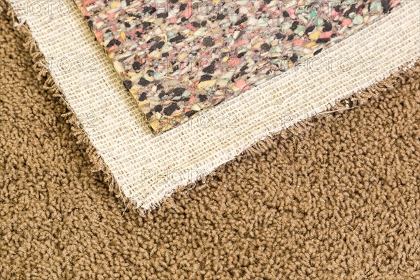 Pulled back carpet and underlay in room of house