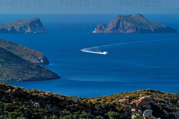 Speeding speed boat catamaran ferry vessel in Aegean sea near Milos island on summer day in Greece