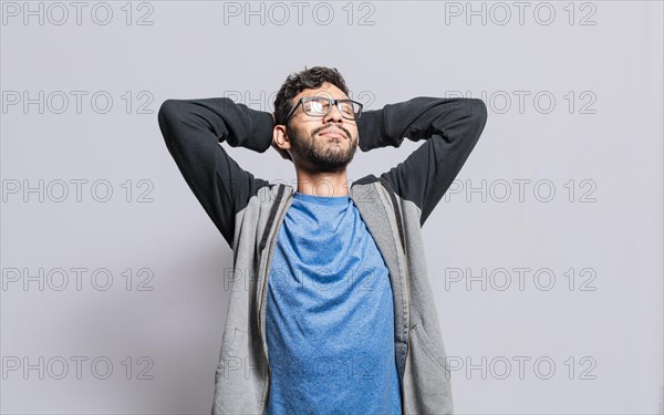 Relaxed person with closed eyes with hands behind his head isolated