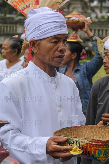 Hindu priest with basket for offerings