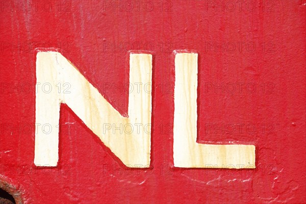 Country sign Netherlands on a red ship's side