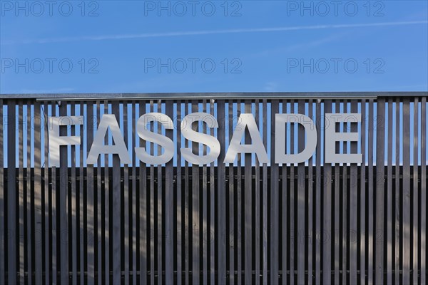 Lettering facade on wooden palisade