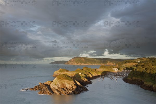 Rain clouds gathering in the evening over the rocky coastal peninsula and bay