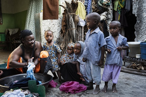 Woman with laundry in plastic bowl