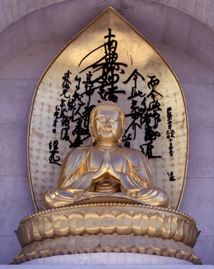 Gilded statue of Buddha on Vishwa Shanti Stupa in Rajgir