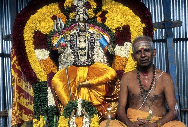 Decorated god with priest