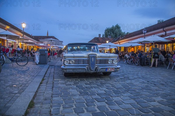 Evening scene in the Stadtamhof nightlife district with US street cruiser as eye-catcher
