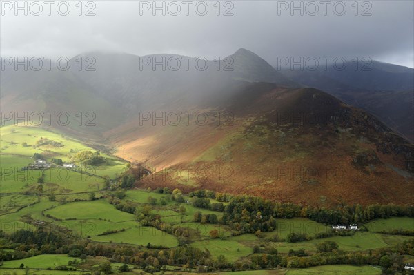 View of valley and fall with rain gusts overhead