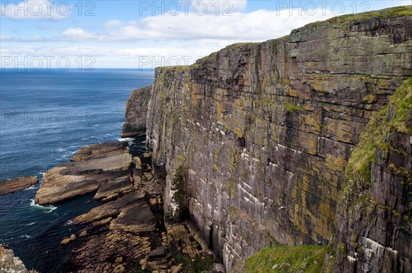 View of Torridonian red sandstone sea cliffs in northwest of island