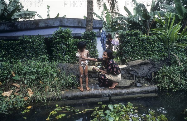 A Woman Bathing her daughter