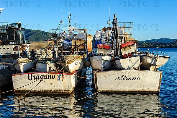 Local fishing boats moored side by side in Mediterranean harbour