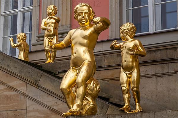 Golden figures on angel's staircase in front of Potsdam City Palace