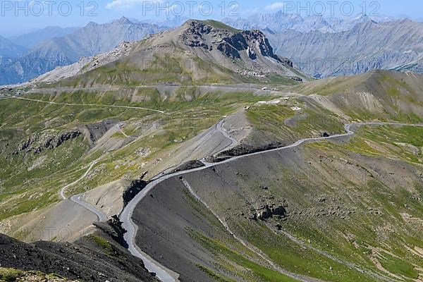 View from Cime de la Bonette on high alpine mountain landscape with alpine pass Col de la Bonette in the middle
