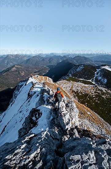 Climbers on the summit ridge with first snow in autumn