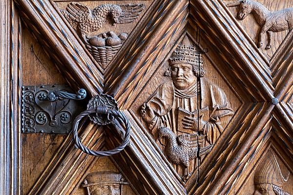 Richly decorated wooden portal of the collegiate parish church of St. Philip and St. James