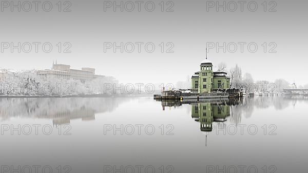 Snowfall and fog at the Helmovsky Jez hydroelectric power plant power station in Prague