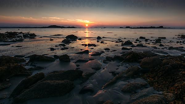 Rocks on the beach of Port Blanc in the evening light
