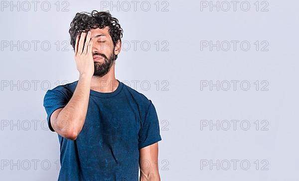 Exhausted person putting the palm of his hand on his face. Tired and exhausted man covering his face with the palm of his hand, Concept of a bored and tired man