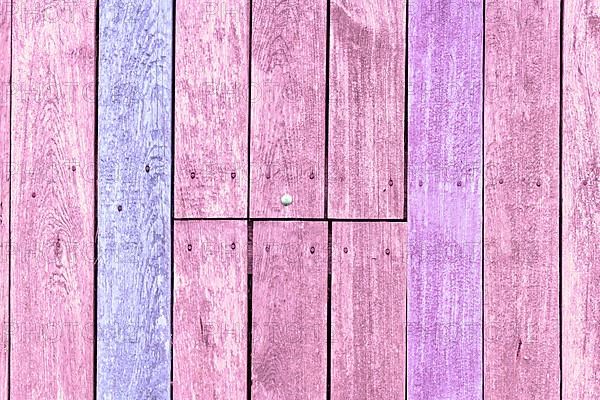 Wooden background with pink and purple painted planks,