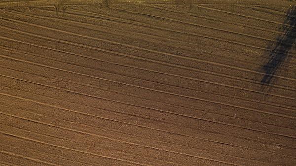 Aerial view of plowed agricultural field ready for planting,