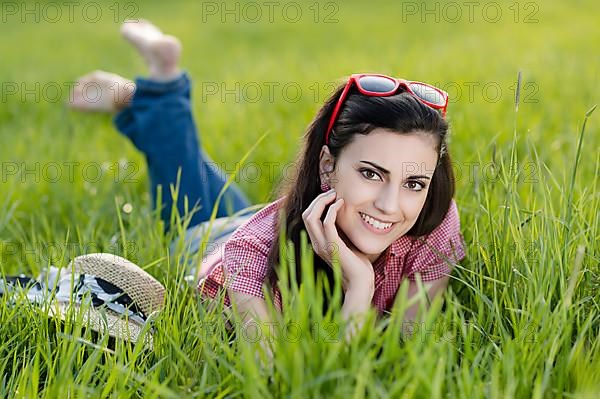 Young woman lying in meadow,