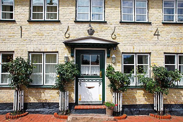 Old house from 1664 with decorative wooden door, Historic fishing settlement Holm