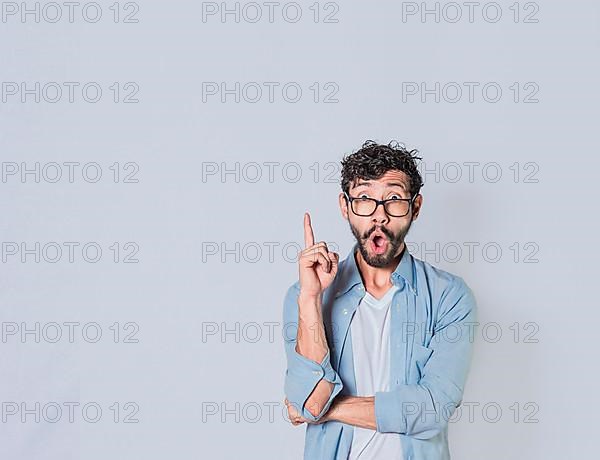 Surprised man pointing up with a new idea, Amazed person pointing an advertisement up