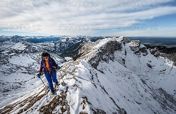 Climber on a rocky snowy ridge, hiking trail to Ammergauer Hochplatte