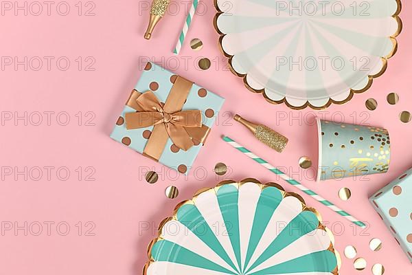 Party flat lay with teal blue paper plates, gift box