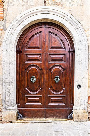 Round arched house entrance door, edged with white marble