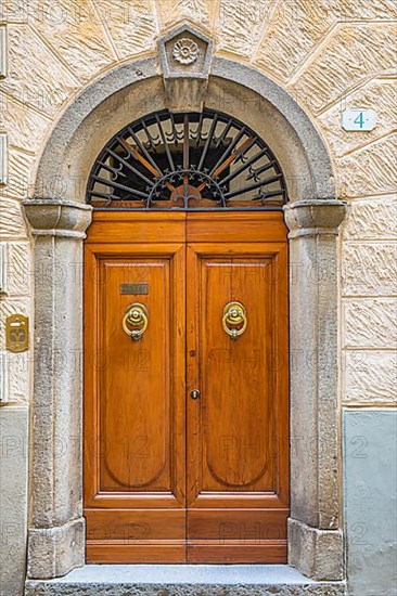 Ornate round arch front door, Montalcino