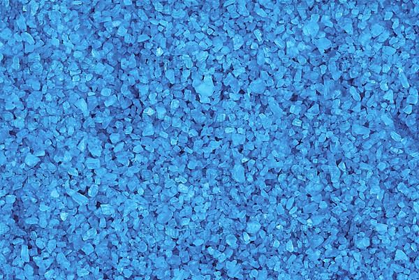 Blue mineral bath salt top view background,