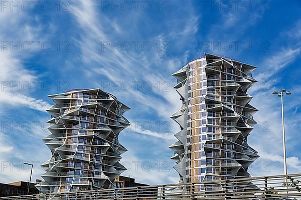 Two dramatically shaped residential towers, high-rises side by side