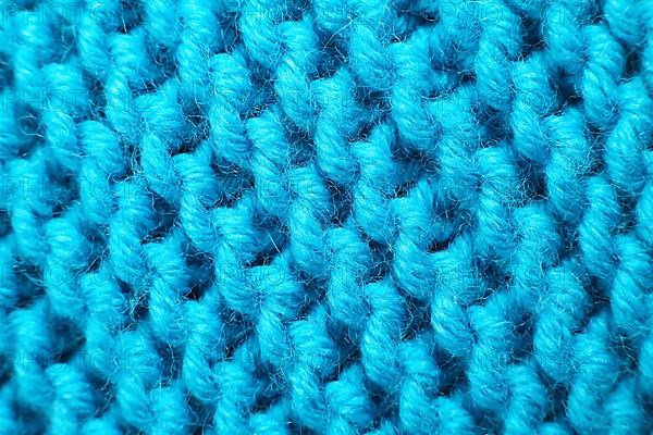 Knitted wool blanket in the colour magenta. Macro,