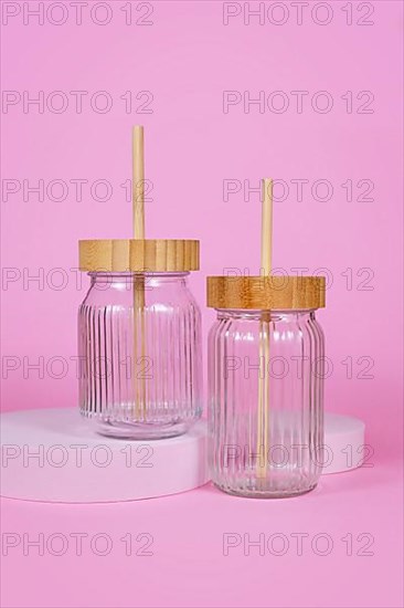 Natural material jars with drinking straws made from glass, wood and bamboo