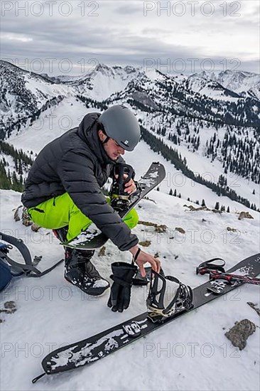 Ski tourers, man assembles his splitboard