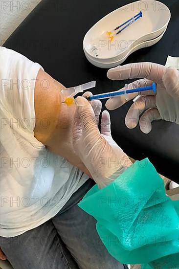 Elderly woman receives injection with medical syringe fourth vaccination booster vaccination against coronavirus disease Covid-19 C19 corona virus Corona virus, Germany