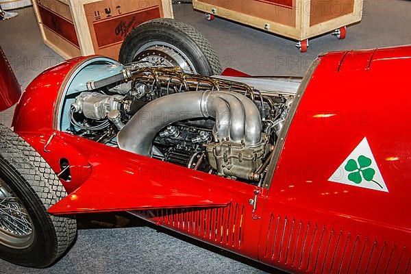 View into engine compartment of historic Italian racing car Alfa Romeo GP Tipo 158 Alfetta first Formal 1 winner 1950 50s, right logo Quadrifoglio four-leaf clover number plate for high-performance Al...