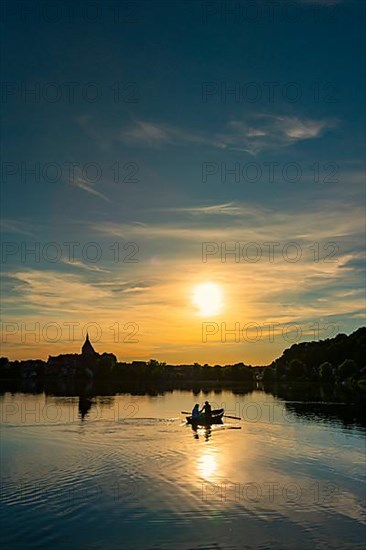 Rowing boat at sunset on the Ziegelsee, Moelln