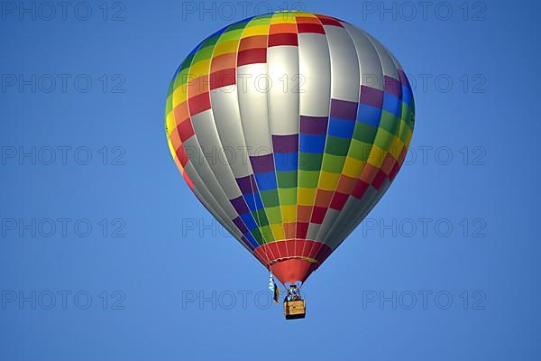 Beautiful colourful hot air balloon in the air with blue sky