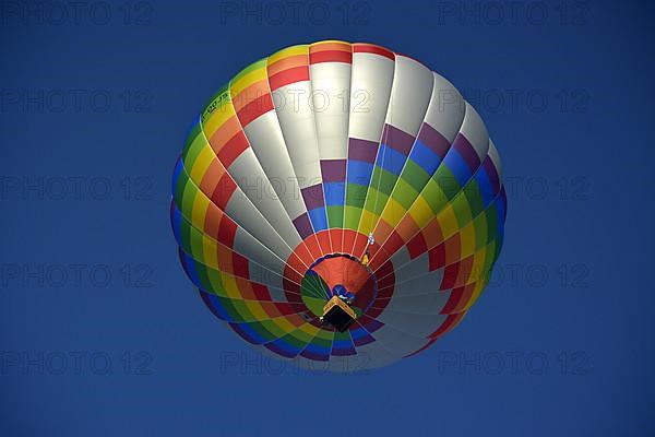 Beautiful colourful hot air balloon in the air with blue sky