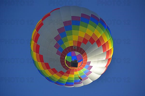 Beautiful colourful hot air balloon in the air with blue sky
