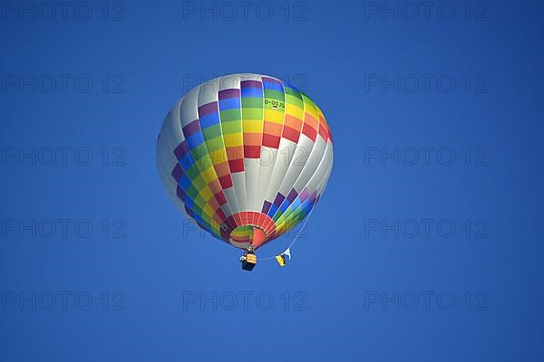 Beautiful colourful hot air balloon in the air with blue sky