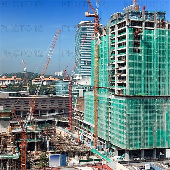 Building house constraction site with cranes. Square format