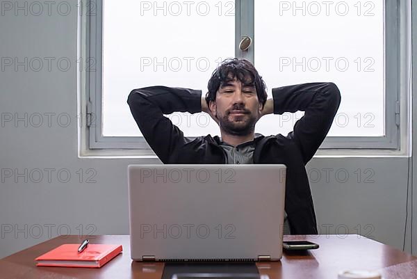 Relaxed businessman at the work desk