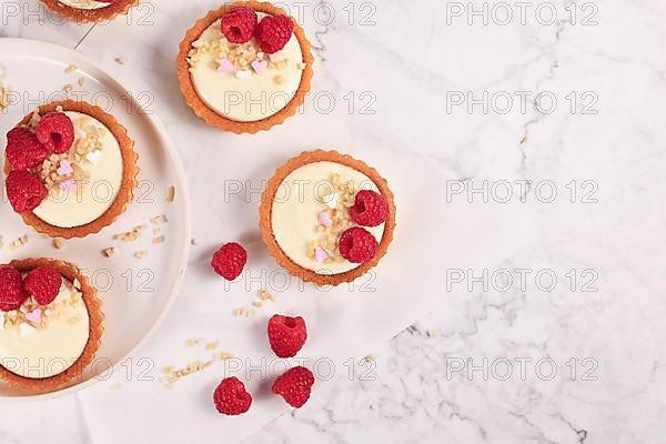 Top view of small tartlet pastries with white cream