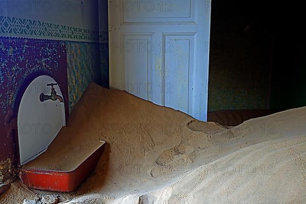 Residential buildings taken over by desert sand