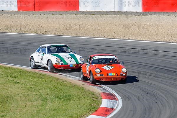Two historic racing cars Porsche 911 close together in curve at car race for classic cars Youngtimer Classic Cars 24-hour race 24h race